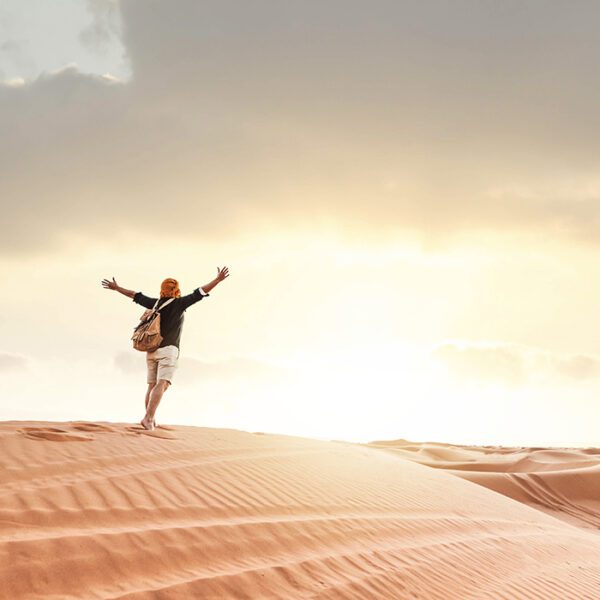 man walking in desert